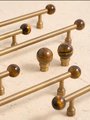 Bronze bar handle resting on tiger eye stone ball/Bronze and tiger eye cabinet handle/Semi precious stone and aged brass furniture hardware