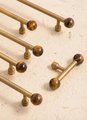 Bronze bar handle resting on tiger eye stone ball/Bronze and tiger eye cabinet handle/Semi precious stone and aged brass furniture hardware