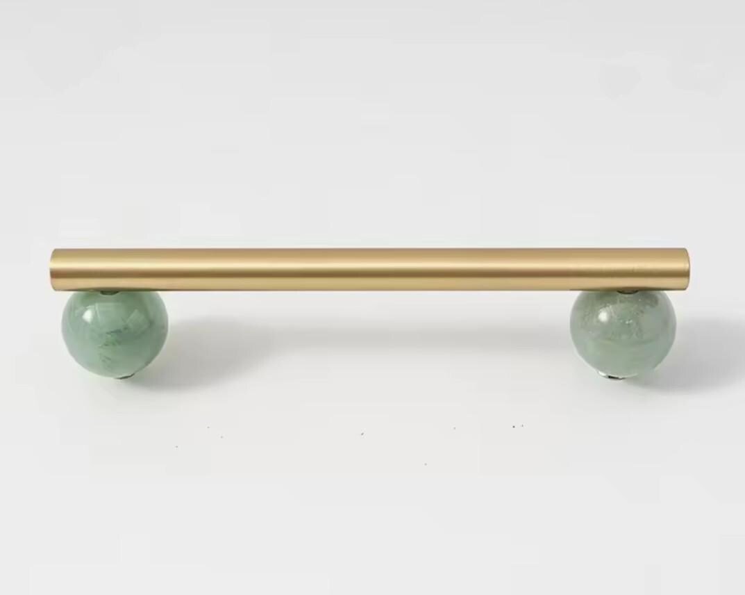 Silky matte gold brass bar handle resting on semi precious stone balls/colourful cabinet handle/stone furniture hardware/crystal drawer pull